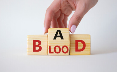 Breed Bad Blood symbol. Businessman hand turns wooden cubes with words Breed Bad Blood. Beautiful white background. Breed Bad Blood and business concept. Copy space