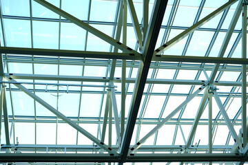metal ceilings, glazed panels, intersecting geometric beams of the building, abstract background for the designer, beautiful ceiling in the modern hall of the European airport