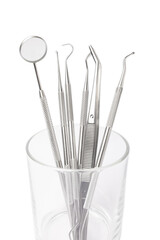 Dental instruments in a glass isolated on white background. Professional tools for oral care. Whitens teeth, stimulates gums, removes plaque and tartar. Clean teeth.Dentistry concept. Collage. Design.