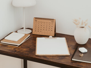 Clipboard with blank paper with copy space on wood brown desk.