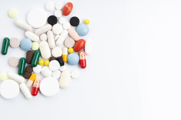 Pack of pills and different pills and capsules on a white background with space for text