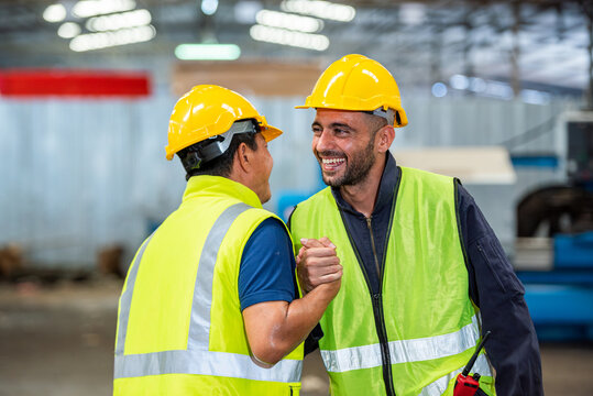 greeting by handshake touch fist and elbow of two engineer supervisor partnership in old factory. foreman greeting friend for good friendship colleague laborer in teamwork factory.