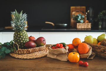 Close-up of vegetables and fruits on a wooden table in the background of the kitchen. Balanced diet, cooking, nutrition concept