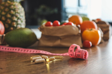 Vitamins and meter on the table against the background of food . diet concept, loss weight