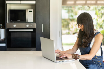 Business woman working from home while looking at laptop. Confident woman using laptop. Copy space.