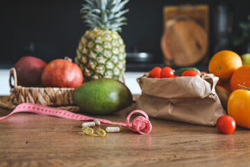 Vitamins and meter on the table against the background of food . diet concept, loss weight
