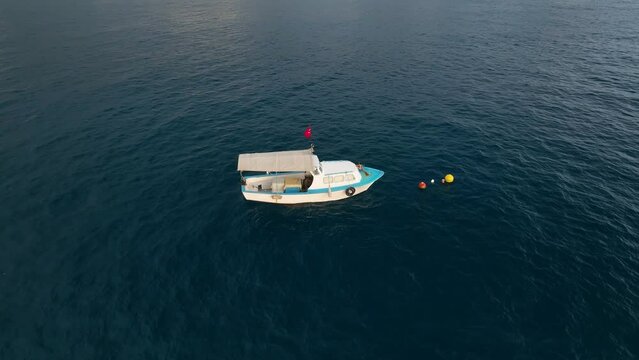 Colors of the Sea: Cinematic Drone Showcases Fisherman's Boat and Underwater Fishing in the Majestic Mediterranean Sunset