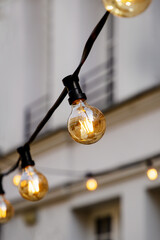 Bright light bulbs on a wire on a wall background