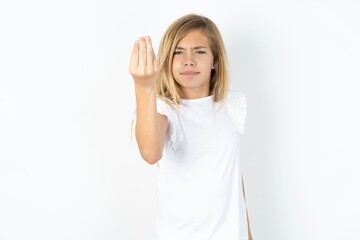 beautiful caucasian teen girl wearing white T-shirt over white wall Doing Italian gesture with hand and fingers confident expression