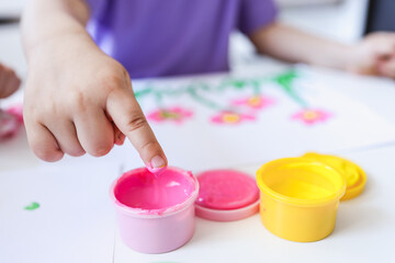 Finger painting. Close-up. Fingers of children's hands in bright paint. Early development. Hobby