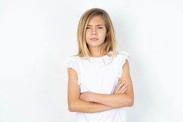 Fototapeta premium beautiful caucasian teen girl wearing white T-shirt over white wall Pointing down with fingers showing advertisement, surprised face and open mouth