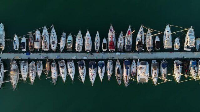 Drone Top view aerial footage of many yachts and boats in the harbor. The drone rises smoothly upwards. Mediterranean Sea, Alanya,Turkey