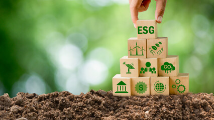 concept of ESG environment icon in hand revolving nature, earth, society and governance SG in sustainable business on network connection on green background environment icon