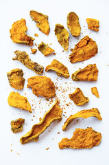 Naklejka premium Sliced dried turmeric root. Curcuma spice used for homeopathic, alternative medicine.