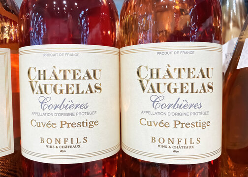 Viersen, Germany - May 9. 2023: Closeup of bottles Chateau Vaugelas french rose wine from Corbieres in shelf of german supermarket