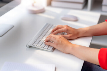 Close-up of hand of businesswoman working using laptop computer to record and print information for a marketing plan analyze the balance sheet report quarterly financial statement.