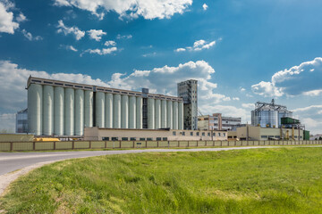 Fototapeta na wymiar agro silos granary elevator with seeds cleaning line on agro-processing manufacturing plant for processing drying cleaning and storage of agricultural products