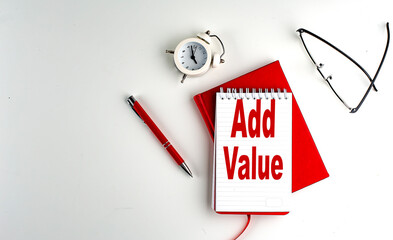 ADD VALUE text on notebook , red pen and notebook, business concept, white background