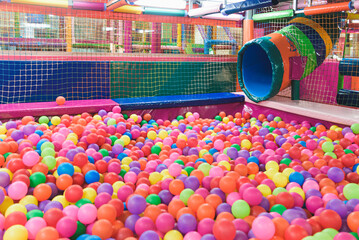 Indoor children's playground in the amusement park with colored balls to play / Inside the beautiful children's playground colored plastic ball of the game room