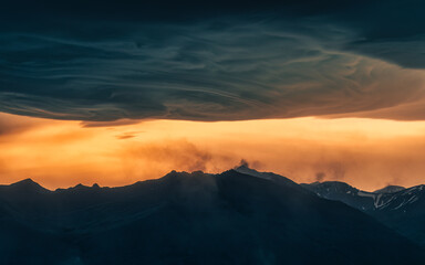 Naklejka na ściany i meble Dramatic of colorful sunset sky and Asperitas cloud over Icelandic mountain at Iceland