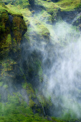 Fototapeta na wymiar Mystery waterfall flowing with foggy in lush canyon