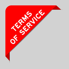 Red color of corner label banner with word terms of services on gray background