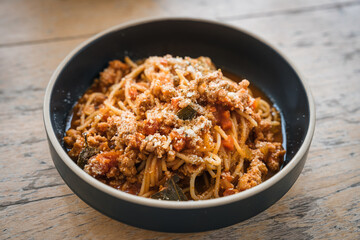 Spaghetti tomato sauce minced pork and cheese of italian food in black plate