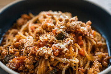 Spaghetti tomato sauce minced pork and cheese of italian food in black plate