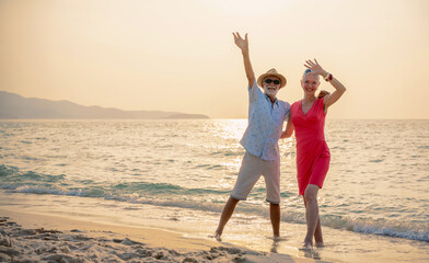 Senior couple relaxing and spend time together at tropical beach., Healthy seniors lifestyle concept.