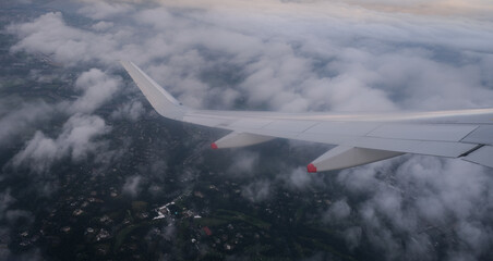 Fototapeta premium Plane in flight above London city united Kingdom. Aerial top view from air wing plane window