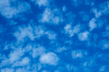 Fototapeta na wymiar light white clouds on bright blue blue sky in summer
