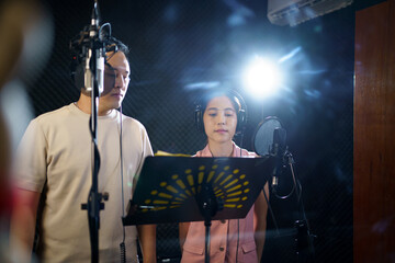 Asian professional singers recording in audio recording studio, professional male and female singer...