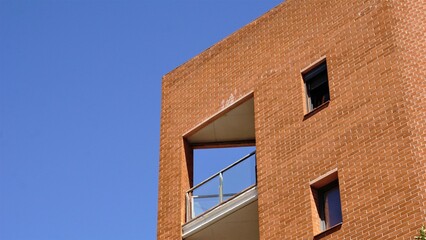 facade with brick balcony against the sky
