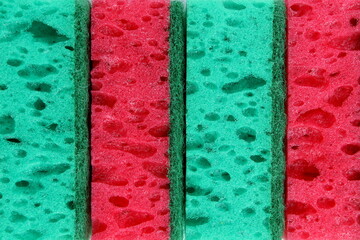 the background is a lot of soft sponges for dishes in green and red.