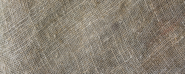 Sturdy rough sackcloth textured background panoramic view. Burlap detail backdrop.