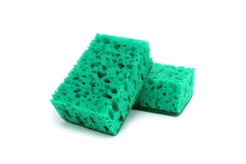 Two green sponges for washing dishes lie on a white background.	