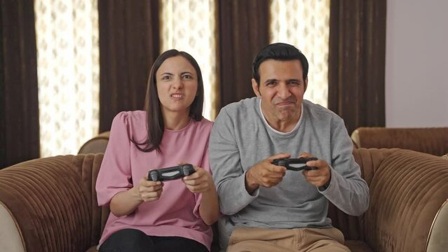 Competitive Indian couple playing video games