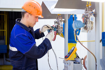 Instrumentation and control engineer diagnoses the operation of gas distribution station equipment...