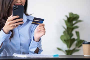 Beautiful Asian women using credit cards for shopping online with laptops and smartphones, online shopping portrait concept.