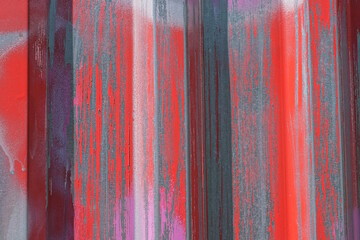 metal texture from a gray iron wall in spots of red paint