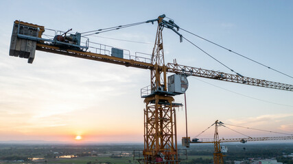 Fototapeta na wymiar A construction site with yellow tower crane