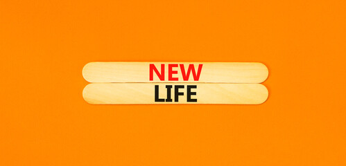 New life symbol. Concept words New life on beautiful wooden stick on a beautiful orange table orange background. Business, support, motivation, psychological and new life concept. Copy space.