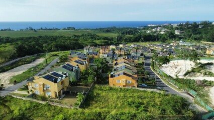 Fototapeta premium Drone shot of Savannah at the Vistas surrounded by trees at the Saint Ann Parish, Jamaica