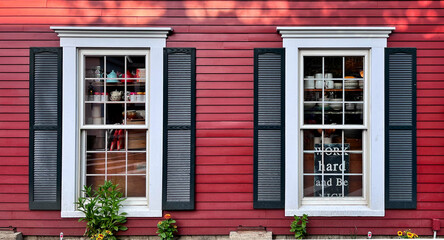 Fototapeta na wymiar windows in historic red building (shopping, siding, glass, moldings, decorative) vintage hotel (inn, bed and breakfast) travel tourism