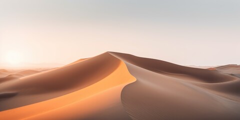 Fototapeta na wymiar Sand dunes. The sun is setting on the mountain and there is a beautiful warm orange light.