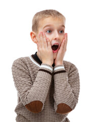 Portrait of seven year old boy excited lucky receive unbelievable awesome present, isolated on white. Schoolboy in brown sweater touch cheeks surprised open mouth impressed posing in studio.