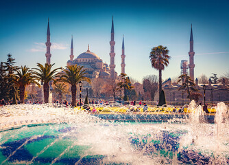 Fototapeta na wymiar Attractive summer view of Sultan Ahmet park in Istanbul. Splendid outdoor scene of capital of Turkey with a tots of tourists and sparkling fountain. Traveling concept background.