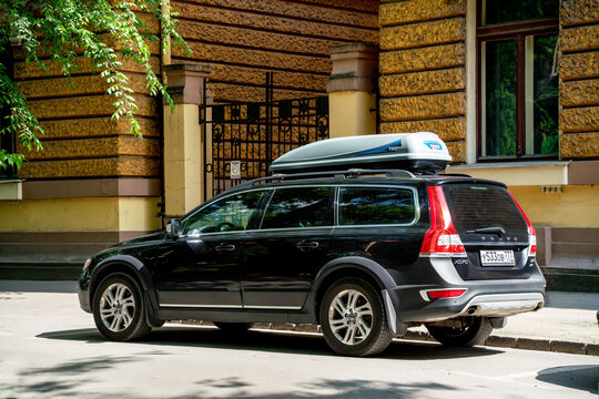 Black Volvo XC70 (v70 XC) (second generation) with Thule roof rack box is parked in Subotica, Serbia -  27.05.2023. Back side view.