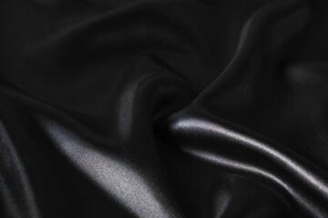 Obraz premium Silk fabric, abstract wavy black satin fabric background.