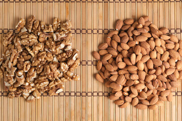 Peeled walnuts and almonds are laid out bamboo substrate.